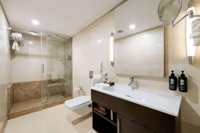 a bathroom with a sink and a shower and a toilet at Ramada Plaza By Wyndham Istanbul City Center in Istanbul