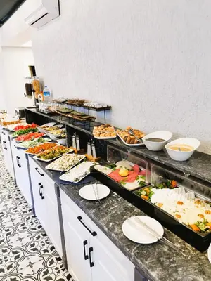 a buffet line with many different types of food at Luxx Garden Hotel in Istanbul