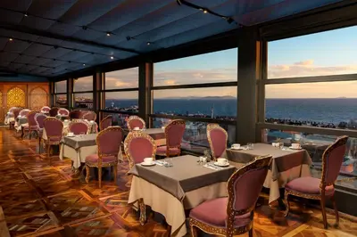 a dining room with tables and chairs and large windows at AJWA Sultanahmet - Preferred Hotels LVX Collection in Istanbul