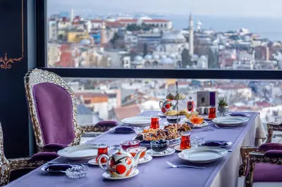 a table with food on it in front of a window at AJWA Sultanahmet - Preferred Hotels LVX Collection in Istanbul