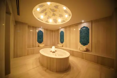 a lobby with a round table and a chandelier at Almira Hotel Thermal Spa & Convention Center in Bursa