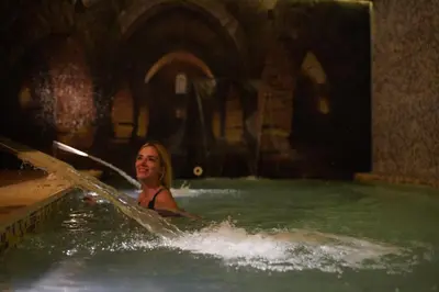 a woman in a pool of water with a paddle at Almira Hotel Thermal Spa & Convention Center in Bursa