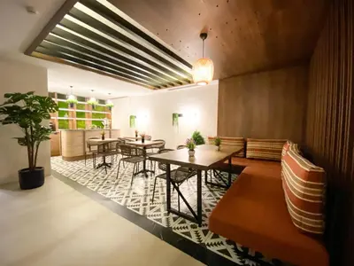 a lobby with tables and chairs in a room at Almira Hotel Thermal Spa & Convention Center in Bursa