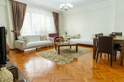 a living room with a couch and a table at Kaplan Cosy Flat - All air conditioned & Heated 3 Bedrooms in the City in Istanbul