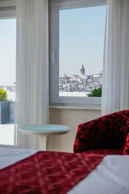 a bedroom with a bed and a table and a window at Dream Bosphorus Hotel in Istanbul