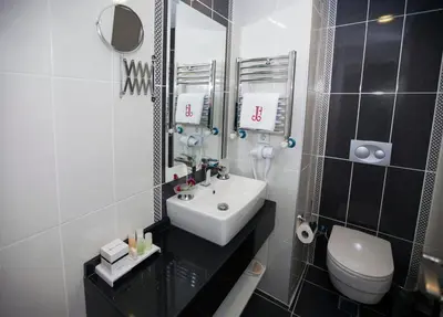 a bathroom with a sink and a toilet and a mirror at Dream Bosphorus Hotel in Istanbul