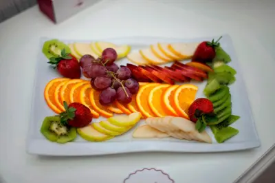 a plate of fruit and vegetables on a table at Dream Bosphorus Hotel in Istanbul