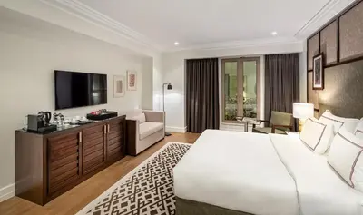 a hotel room with a large bed and a television at The Stay Boulevard Nisantasi in Istanbul