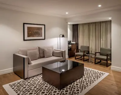 a living room with a couch and two chairs at The Stay Boulevard Nisantasi in Istanbul