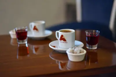 a wooden table with two cups of coffee and drinks at Antea Hotel Oldcity -Special Category in Istanbul
