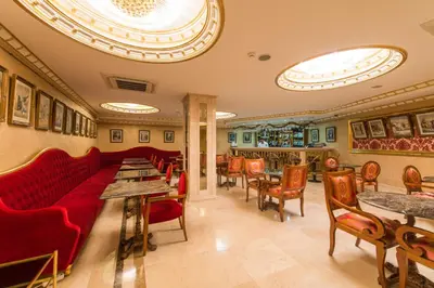 a restaurant with red couches and tables and chairs at Antea Hotel Oldcity -Special Category in Istanbul