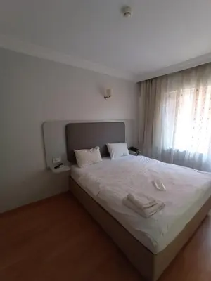 a bedroom with a bed with two white towels on it at Emin Konak Hotel in Istanbul