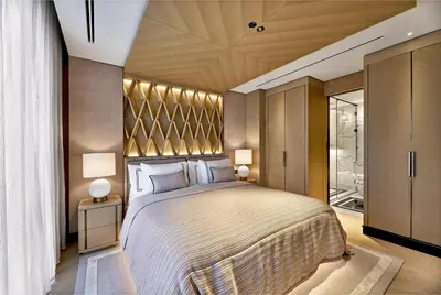 a bedroom with a large bed with two lamps at Vakko Hotel and Residence in Istanbul