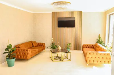 a living room with two couches and a tv at PETRA HOTEL TUZLA in Tuzla