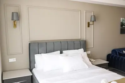 a bedroom with a large bed with white pillows at PETRA HOTEL TUZLA in Tuzla