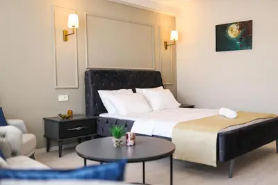 a hotel room with a bed and a couch at PETRA HOTEL TUZLA in Tuzla