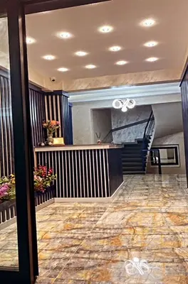 a lobby with a staircase in a building with a lobby at BALPETEK HOTEL in Istanbul
