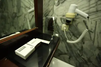a bathroom with a phone on a counter next to a mirror at Asmali Hotel in Istanbul