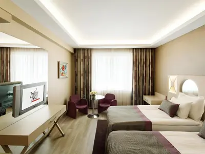 a hotel room with two beds and a television at WOW Istanbul Hotel in Istanbul