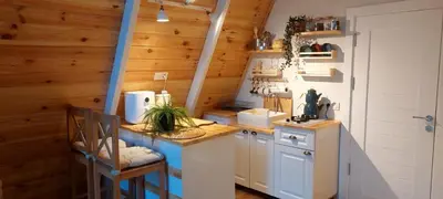 a kitchen with wooden walls and a counter with a sink at VADİ BUNGALOV SAPANCA in Sapanca