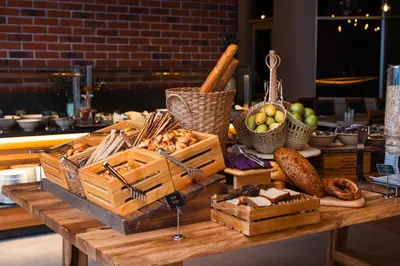a table with baskets of bread and vegetables on it at WOW Airport Hotel in Istanbul
