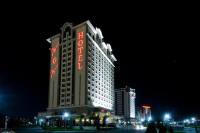 a tall building with a sign on it at night at WOW Airport Hotel in Istanbul