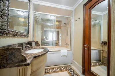a bathroom with a sink and a shower and a tub at The Central Palace Taksim in Istanbul
