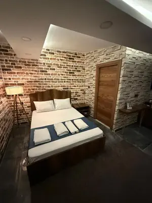 a bed in a room with a brick wall at La Vien Hotel Old City in Istanbul