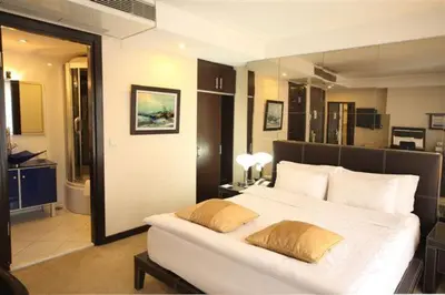 a bedroom with a large white bed with two pillows at Cartoon Hotel in Istanbul