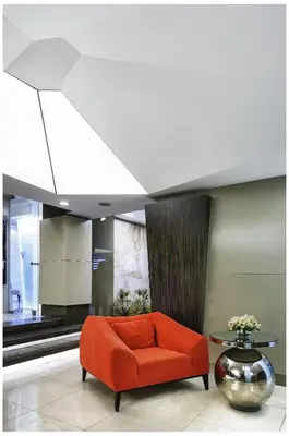 an orange couch in a room with a table at Cartoon Hotel in Istanbul