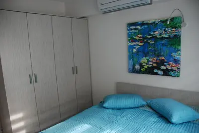 a bedroom with a bed and a painting on the wall at Bursa Park Apart Hotel in Bursa