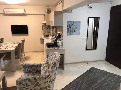 a kitchen and living room with a table and chairs at Bursa Park Apart Hotel in Bursa