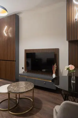 a living room with a table and a large television at Nm Suites Beyoglu in Istanbul