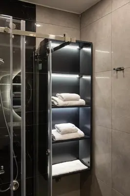 a bathroom with a glass shower stall with towels at Nm Suites Beyoglu in Istanbul
