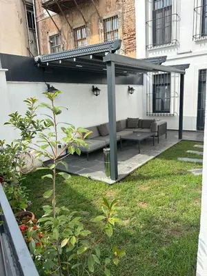 a patio with a couch under a pergola at Nm Suites Beyoglu in Istanbul