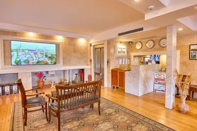 a living room with a tv on the wall at Ardey Hotel in Istanbul