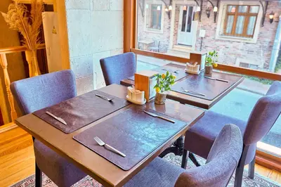a table in a room with chairs and a table sidx sidx at Ardey Hotel in Istanbul