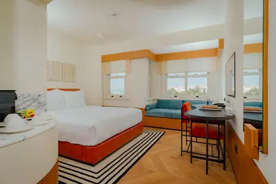 a hotel room with a bed and a desk and a kitchen at The Gift Hotel in Istanbul