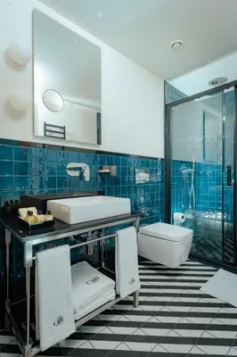 a blue tiled bathroom with a sink and a tub at The Gift Hotel in Istanbul