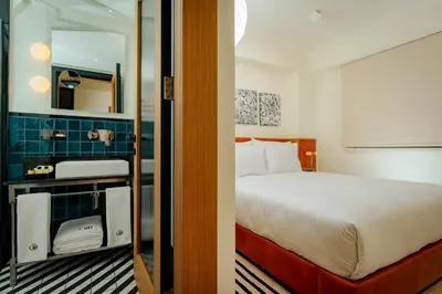 a hotel room with a bed and a mirror at The Gift Hotel in Istanbul