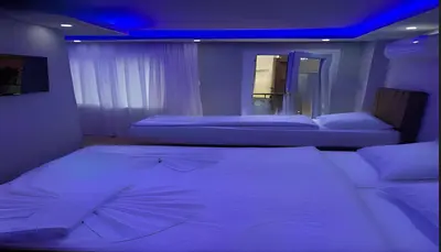 a bedroom with two beds and a blue ceiling at BLUE ROYAL HOTEL in Istanbul