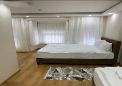 a bedroom with a large bed with white curtains at BLUE ROYAL HOTEL in Istanbul