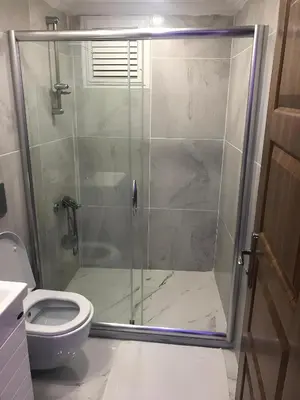 a bathroom with a glass shower with a toilet at BLUE ROYAL HOTEL in Istanbul