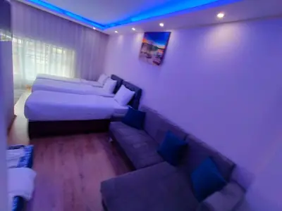 a living room with a couch and a bed at BLUE ROYAL HOTEL in Istanbul