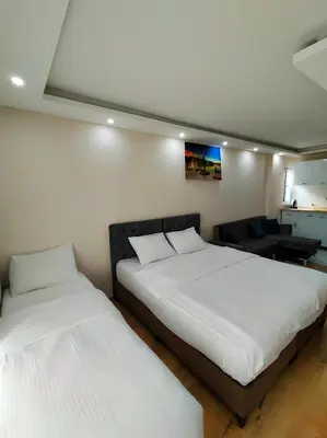 two beds in a room with white sheets at BLUE ROYAL HOTEL in Istanbul