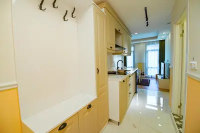 a kitchen with wooden cabinets and a white counter top at Cihangir VAV Suites in Istanbul