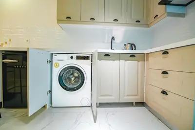 a kitchen with a washing machine and a sink at Cihangir VAV Suites in Istanbul
