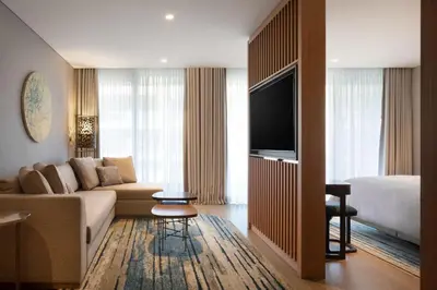 a living room with a couch and a tv and a bed at The Westin Istanbul Nisantasi in Istanbul