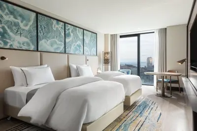 two beds in a hotel room with a view at The Westin Istanbul Nisantasi in Istanbul