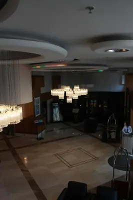 a large lobby with chandeliers and a large room at Byotell Istanbul in Istanbul